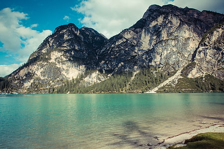 mountain peak near body of water thumbnail