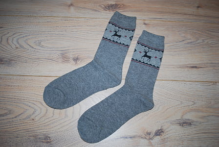 pair of gray socks placed on brown wood thumbnail