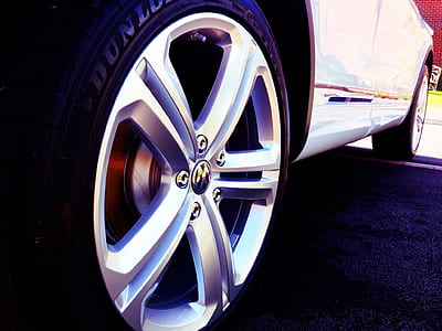 selective focus photography of silver Volkswagen 5-spoke vehicle wheel and tire thumbnail