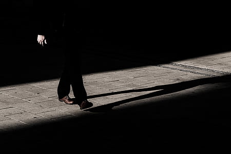 woman wearing black pants stand on gray pavement thumbnail