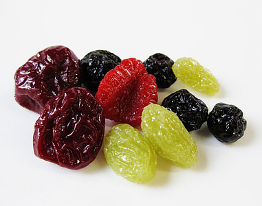 green, brown, and black raisins on white surface thumbnail