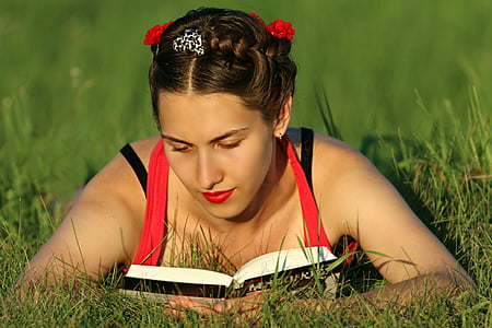 brown haired woman wearing red and white halter top on grass field thumbnail