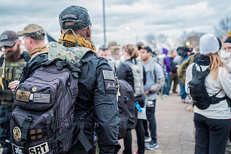 man carrying backpack thumbnail