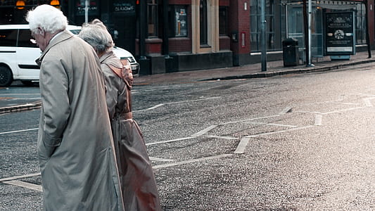 man and woman walking on road thumbnail