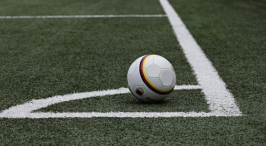 white soccer ball on grass field near line thumbnail
