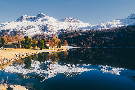 mountain covered with snow and body of water photo thumbnail