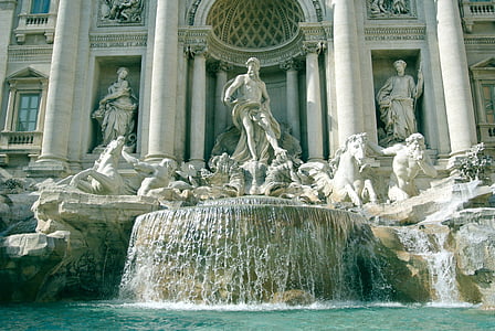 concrete fountain near building during daytime thumbnail