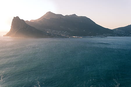 sea and mountain during daytime thumbnail