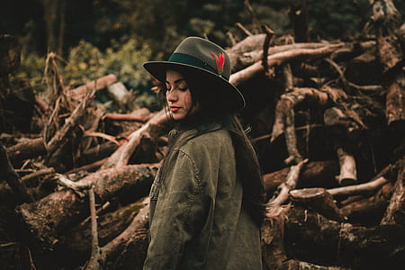 woman side view photo standing beside logs thumbnail
