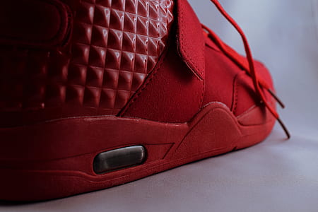unpaired red lace-up shoe on white surface thumbnail