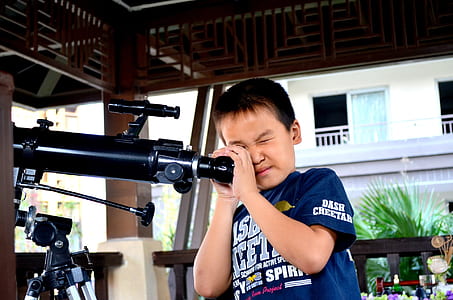 boy holding telescope thumbnail