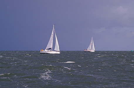 two white sailboats on body of water during daytime thumbnail