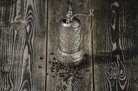 silver pepper mill on wooden surface thumbnail