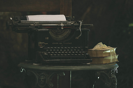 Old typewriter and books on a table thumbnail