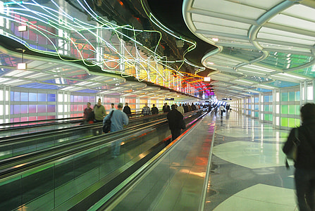 people standing on escalator in airport thumbnail
