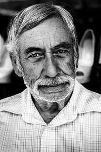 grayscale photo of man wearing button-up top thumbnail