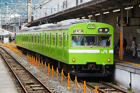 green train on train station during daytime thumbnail