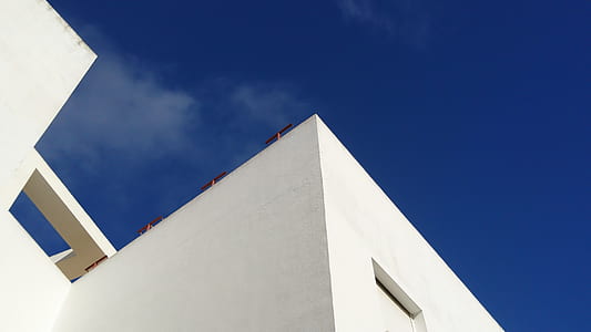 low angle photography of white painted building thumbnail