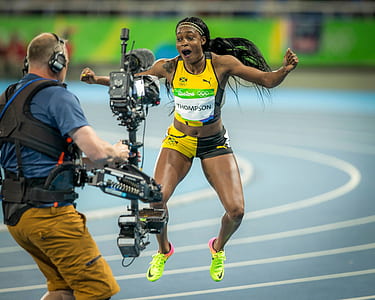 woman wearing yellow and black tank top during in the air because of jumping thumbnail