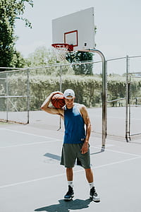 man carrying basketball on his right shoulder during daytime thumbnail