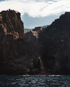 brown concrete building on brown rock mountain at day time thumbnail