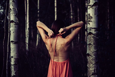 woman facing at trees fixing halter of her dress at daytime thumbnail