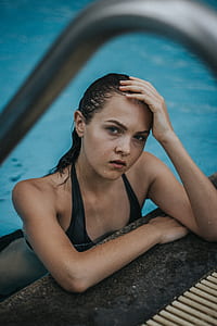 woman in black bikini on body of water thumbnail