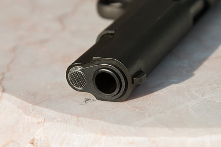 black semi-automatic pistol on white surface thumbnail