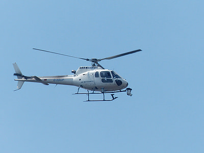 white helicopter under blue sky thumbnail