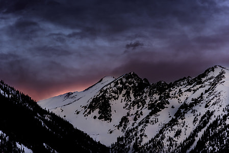snow mountain under purple and orange sky landscape photography thumbnail
