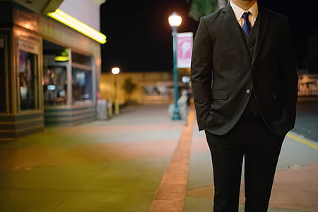 man wearing 2-piece suit set standing near building thumbnail