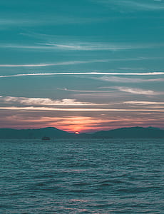 boat far away from island during golden hour thumbnail