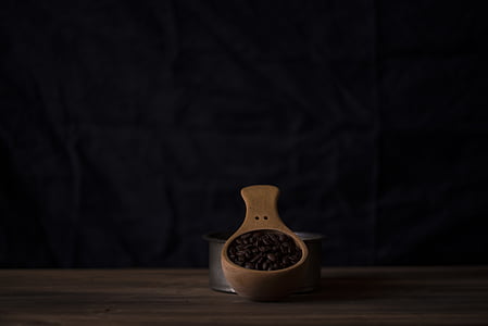 brown wooden container and black coffee beans thumbnail