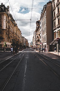 people standing beside concrete buildings thumbnail