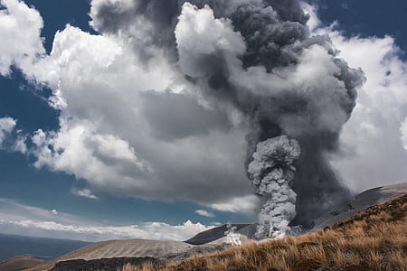 white and gray smoke coming out from a hill thumbnail