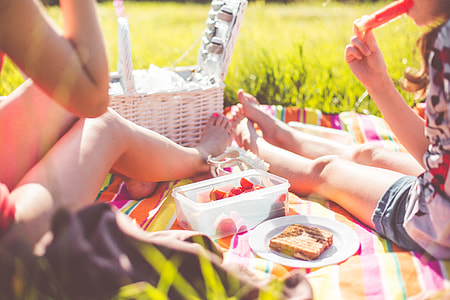 Two Girls Enjoying First Summer Picnic in Nature thumbnail