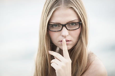 woman wearing black eyeglasses with index finger on her lips thumbnail