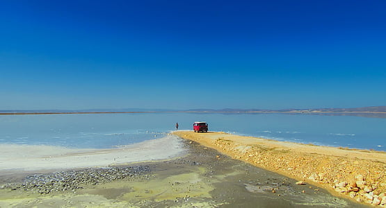 photo of red vehicle near beach thumbnail