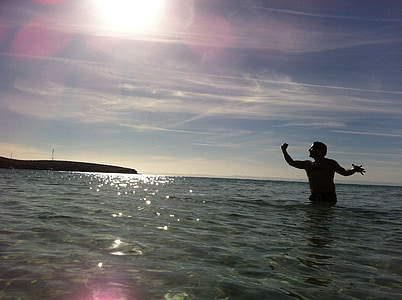 man standing on body of water during daytime thumbnail