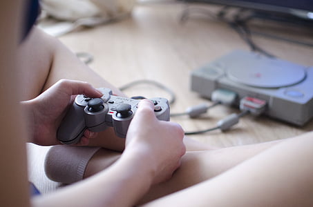 person holding Sony PS1 controller thumbnail