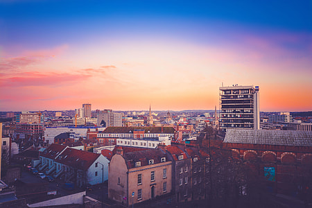 brown and white roof of buildings under orange and blue sky thumbnail
