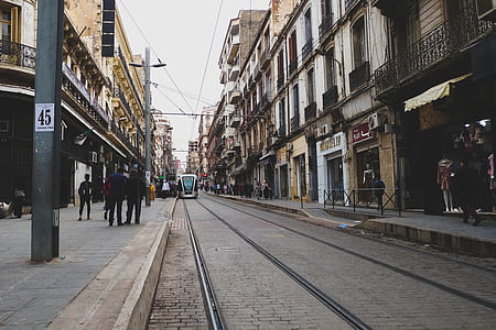 tram near sidewalk under cloudy sky thumbnail