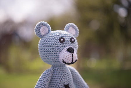 selective focus photography of blue crochet bear plush toy thumbnail