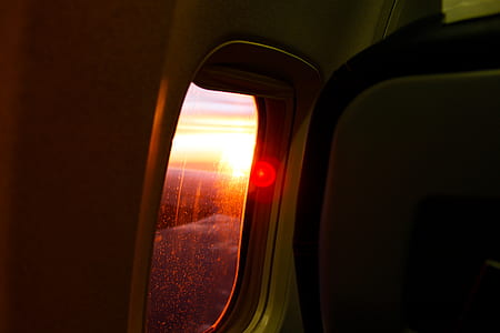 Photography of Airplane Window During Dusk thumbnail