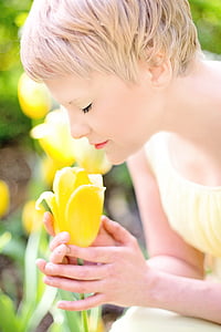 woman smelling yellow tulip flower thumbnail