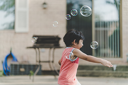 photo of a boy having fun playing with bubbles thumbnail