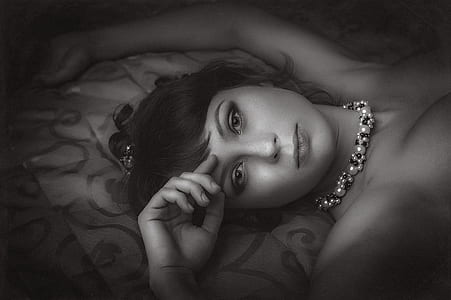 lying woman wearing beaded necklace thumbnail