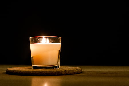 lit white votive candle thumbnail