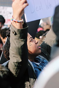 close-up photography of person holding signage during daytime thumbnail