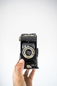 person holding black Kodak land camera thumbnail